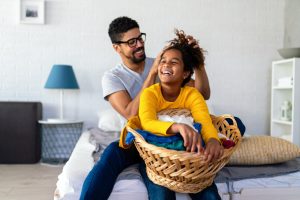 Father and daughter doing the laundry