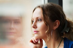 Thoughtful woman looking out window