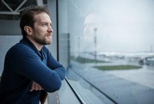Pensive man looking out window