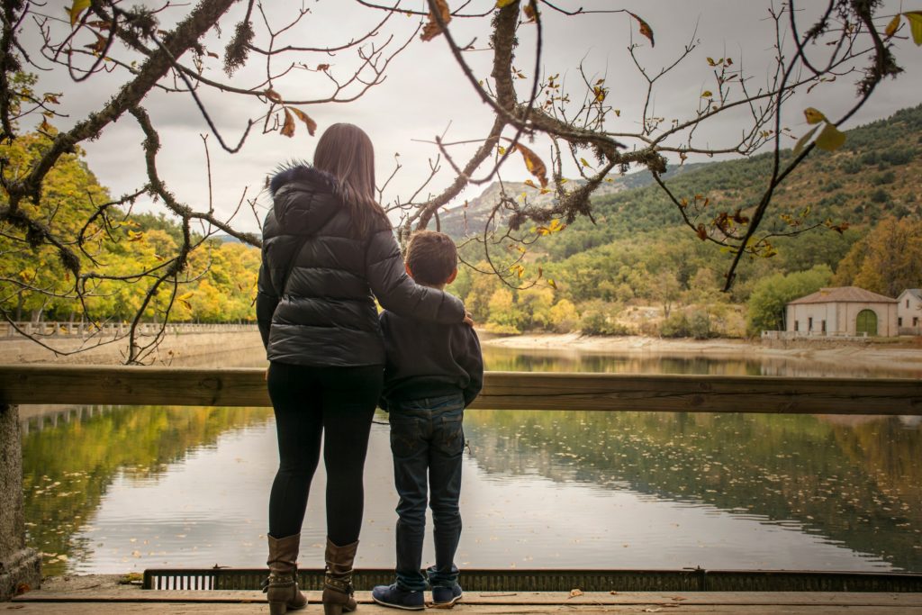 Mother and son looking out onto a lake