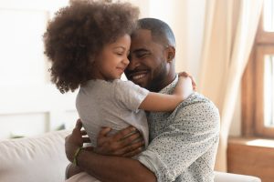 Happy daughter and father hugging